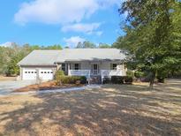 Charming single-story home with a covered front porch and attached two-car garage at 2300 Bethera Rd # A, Bonneau, SC 29431