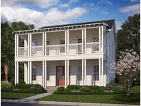 Charming two-story home with a inviting front porch, beautiful landscaping, and traditional architectural details at 520 Rustling Tree Court Ct, Summerville, SC 29486