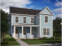 Charming two-story home with light blue siding, white trim, a welcoming porch, and beautifully landscaped front yard at 740 Blueway Ave, Summerville, SC 29486
