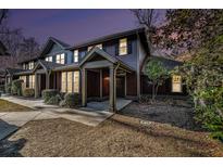 Charming townhome featuring craftsman-style architecture, covered entry, and well-maintained landscaping for curb appeal at 8409 Hidden Bakers Trce, North Charleston, SC 29418