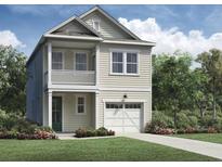 Charming two-story home with a cozy front porch and attached garage, nestled in a beautifully landscaped yard at 100 Hawthorne Landing Dr, Goose Creek, SC 29445