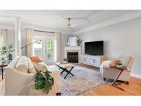 Cozy living room features a fireplace, hardwood floors, ceiling fan, and a seating area at 1025 Riverland Woods Pl # 106, Charleston, SC 29412
