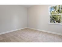Bright bedroom featuring neutral carpeting, a window with backyard views and freshly painted walls at 104 Hawthorne Landing Dr, Goose Creek, SC 29445