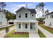 Charming two-story home featuring a welcoming front porch, light blue siding, and a well-manicured lawn at 126 Maritime Way, Summerville, SC 29485