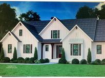 Charming home featuring a white board and batten exterior, dark roof, and lush green lawn at 181 Harvest Way, Walterboro, SC 29488