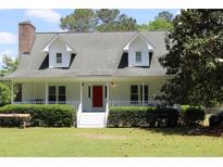 Charming two-story home with white siding, dormer windows and a welcoming front porch at 18808 Round O Rd, Round O, SC 29474