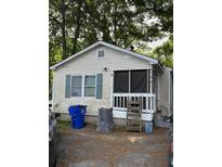 Exterior of a small single-story home featuring a screened porch and light-colored siding at 1921 Quitman St, North Charleston, SC 29405