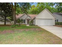 Charming single-story home with a two-car garage and landscaped front yard with mature trees and shrubs at 2154 Country Manor Dr Dr, Mount Pleasant, SC 29466