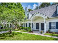 Charming home with a manicured lawn, lovely landscaping and a covered entrance at 3084 Queensgate Way, Mount Pleasant, SC 29466