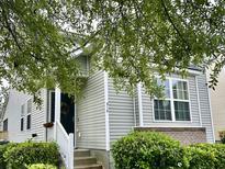 Charming home with gray siding, white trim, inviting entrance, and well-manicured landscaping at 310 Flyway Rd, Goose Creek, SC 29445