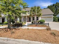 Charming two-story home with manicured landscaping, mature trees, and a two-car garage at 350 Oak Park St, Summerville, SC 29486