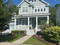 Charming two-story home featuring a welcoming front porch and a well-manicured lawn at 3769 Maidstone Dr, Mount Pleasant, SC 29466
