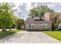 Charming brick home features a spacious parking area and mature trees at 4407 S Shirley Dr, North Charleston, SC 29418