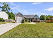Charming single-story home featuring a well-manicured lawn, inviting entrance, and attached one-car garage at 5376 Copley Cir, Summerville, SC 29485