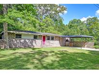 Charming brick home with a well-manicured lawn, covered carport, and lovely, mature trees in a desirable neighborhood at 108 Helen Dr, Summerville, SC 29483
