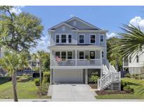Charming two-story home with a front porch, white railings, and well-manicured landscaping at 1513 Cultivation Ln, Mount Pleasant, SC 29466