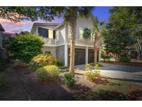 Charming home showcasing a 2-car garage, beautiful landscaping, and timeless coastal architecture at 1551 Ben Sawyer Blvd # 44, Mount Pleasant, SC 29464