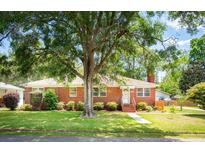 Charming brick home with a well-manicured lawn and mature shade tree in a desirable neighborhood at 1915 Aichele Dr, North Charleston, SC 29406