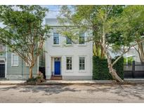 Charming two-story home with a blue front door and beautiful trees in a desirable neighborhood at 23 Felix St, Charleston, SC 29403