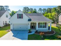Charming home featuring a well-manicured lawn, attached garage, and inviting front porch at 2314 Hummingbird Ln, Summerville, SC 29483