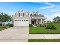 Charming single-Gathering home featuring a well-manicured lawn and a two-car garage with traditional architectural details at 403 Hidden Meadow Ln, Summerville, SC 29486