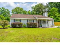 Charming single-story home with gray siding, landscaped yard, and cozy covered porch at 505 Laurel Ridge Rd, North Charleston, SC 29418