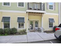 Inviting condo entrance featuring a balcony, double glass doors and chairs on the front porch at 7101 Bowen Corner Ave, Hanahan, SC 29410