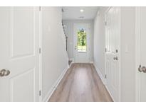 Bright foyer features wood-look flooring, neutral paint, and natural light from the front door at 102 Hawthorne Landing Dr, Goose Creek, SC 29445