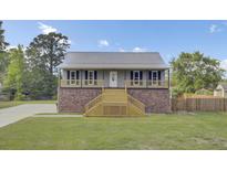 Charming home with a brick foundation, a metal roof, and a welcoming wooden staircase leading to the entrance at 108 Mourning Dove Dr, Bonneau, SC 29431