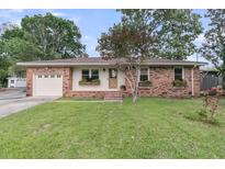 Charming brick home featuring well-maintained lawn, flower boxes, and an attached one-car garage at 108 Williamsburg Ct, Goose Creek, SC 29445