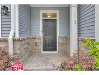 Inviting front door of home with brick accents and decorative plants for a welcoming entrance at 113 Alpine Rd, Summerville, SC 29485