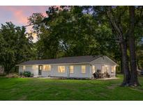 Charming single-story home featuring a well-maintained lawn and large, mature trees at 1192 Church Of God Rd, Bonneau, SC 29431