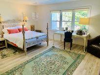 Bright bedroom features a large window, unique decor, and a vintage-style bed at 1202 Ventura Pl, Mount Pleasant, SC 29464