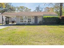 Charming single-story home with a well-maintained lawn and mature landscaping at 1230 Hawthorne Cir, Hanahan, SC 29410