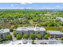 Stunning aerial view of property showcasing mature trees, lakes, and manicured landscaping on a sunny day at 125 Pier View St # 405, Daniel Island, SC 29492