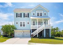 Stunning light blue two-story home featuring a staircase leading to a covered porch and a two-car garage at 1502 Menhaden Ln, Mount Pleasant, SC 29466