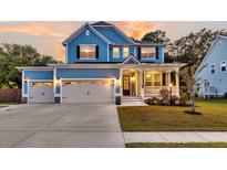 Charming two-story home features a three-car garage, a cozy front porch, and a beautifully landscaped front yard at 1511 Hopkins Ln, Mount Pleasant, SC 29466
