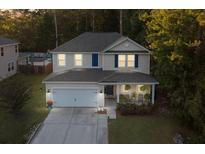Charming two-story home with a well-maintained lawn and attached two-car garage at 314 Beverly Dr, Ladson, SC 29456