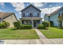 Charming two-story home with a well-manicured lawn and inviting front porch in a suburban neighborhood at 317 Pimpernel St, Summerville, SC 29483