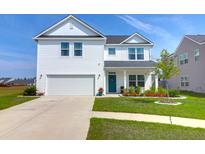 Charming two-story white home with a well-manicured lawn, welcoming curb appeal and attached two-car garage at 408 Trevi Ln, Summerville, SC 29486