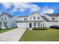 Charming two-story home featuring a well-manicured lawn, two-car garage, and a welcoming front porch at 533 Richfield Way, Summerville, SC 29486