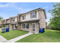 Charming townhome with brick and vinyl siding, complemented by a well-maintained front yard at 5737 Dewsbury Ln, North Charleston, SC 29418