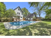 An in-ground pool sits in the backyard of this two story home and additional storage at 699 Castle Pinckney Dr, James Island, SC 29412