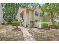 Charming condo with inviting walkway and well-maintained landscaping in a lush, green community at 7965 Edgebrook Cir # F, North Charleston, SC 29418