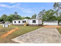 Charming home with a long driveway and detached two-car garage at 119 Silver King Ave, Cross, SC 29436