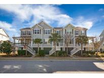 Charming townhome with double porches, palm trees and coastal architecture under a sunny sky at 1624 Prince Edward St, Mount Pleasant, SC 29466