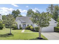 Charming single-story home with a well-manicured lawn and mature landscaping at 1634 Pin Oak Cut, Mount Pleasant, SC 29466
