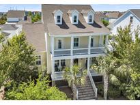 Charming two-story home featuring a spacious double porch and well-maintained landscaping at 1658 Pierce St, Charleston, SC 29492