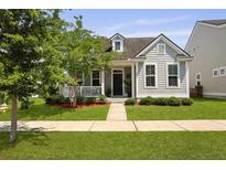 Charming gray home featuring a quaint front porch and a well-manicured lawn at 1722 Winfield Way, Charleston, SC 29414