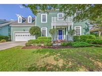 Charming two-story home with a well-manicured lawn and inviting front porch with blue door at 219 Silverwood Ln, Summerville, SC 29485